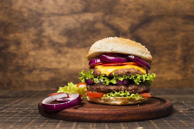 close-up-burger-with-stone-background_23-2148273030