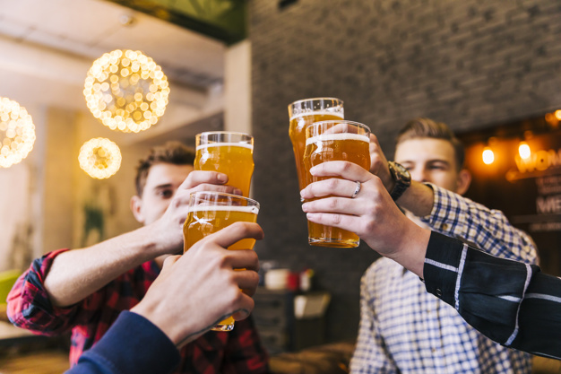 group-friends-celebrating-success-with-beer-glasses_23-2148153835