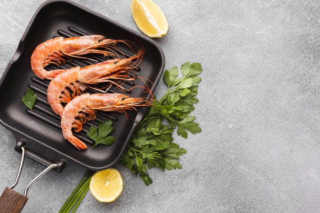 delicious-shrimps-pan-with-condiments_23-2148290486